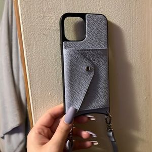 Bandolier leather phone case. Has a card slot, dust bag and cross body strap.